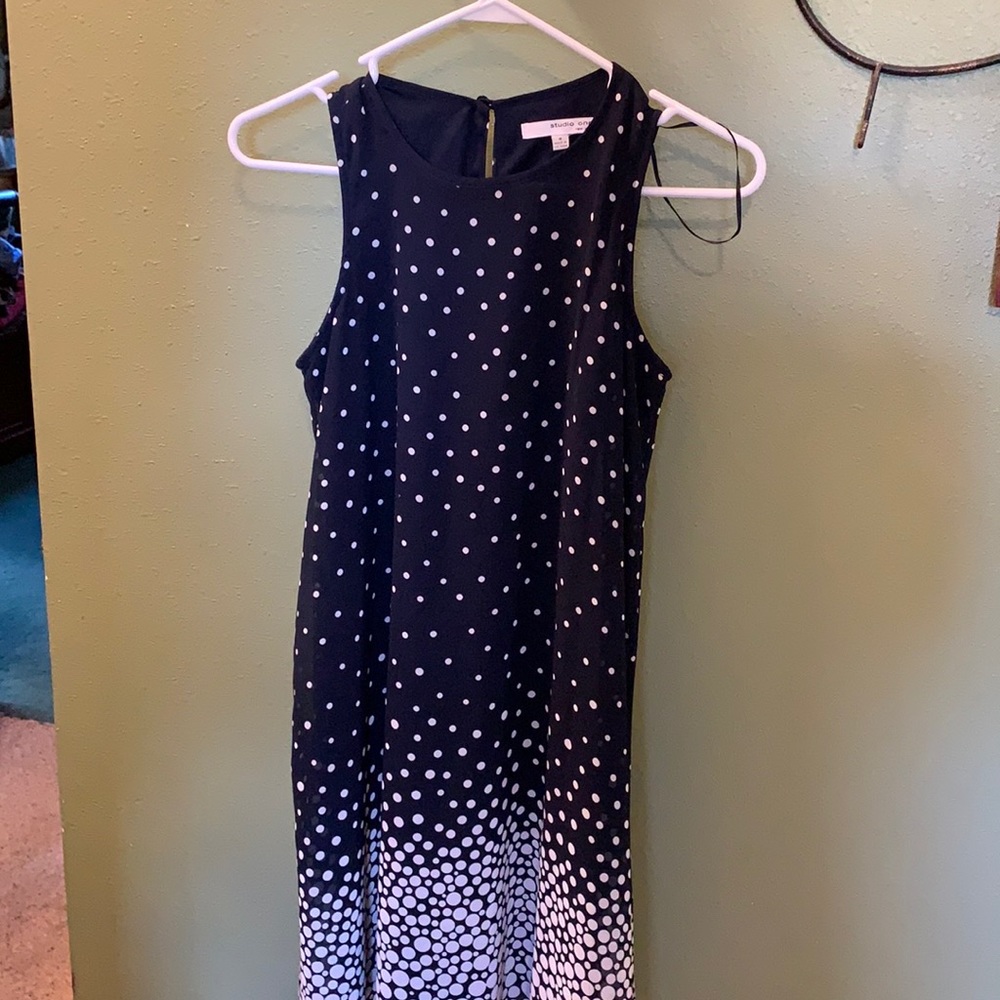 Flowing navy and white polka dot dress.
